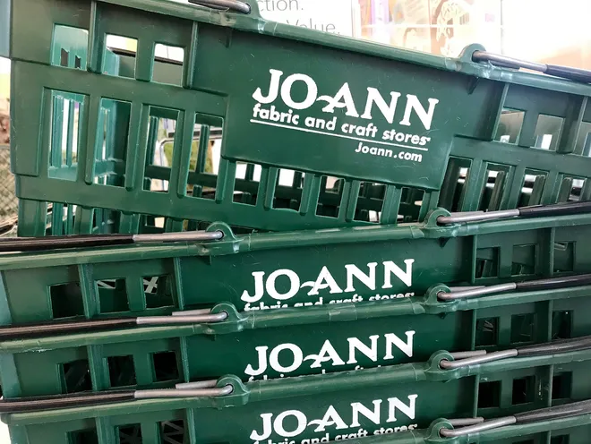 Shoppers outside a Joann Fabrics store during closing sale.